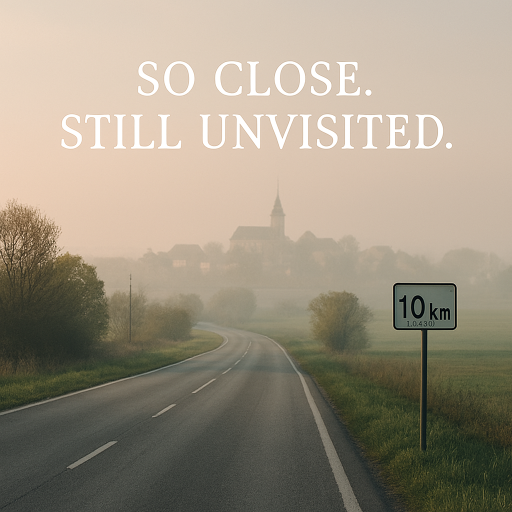 A quiet road and nearby town representing overlooked destinations and delayed personal journeys.